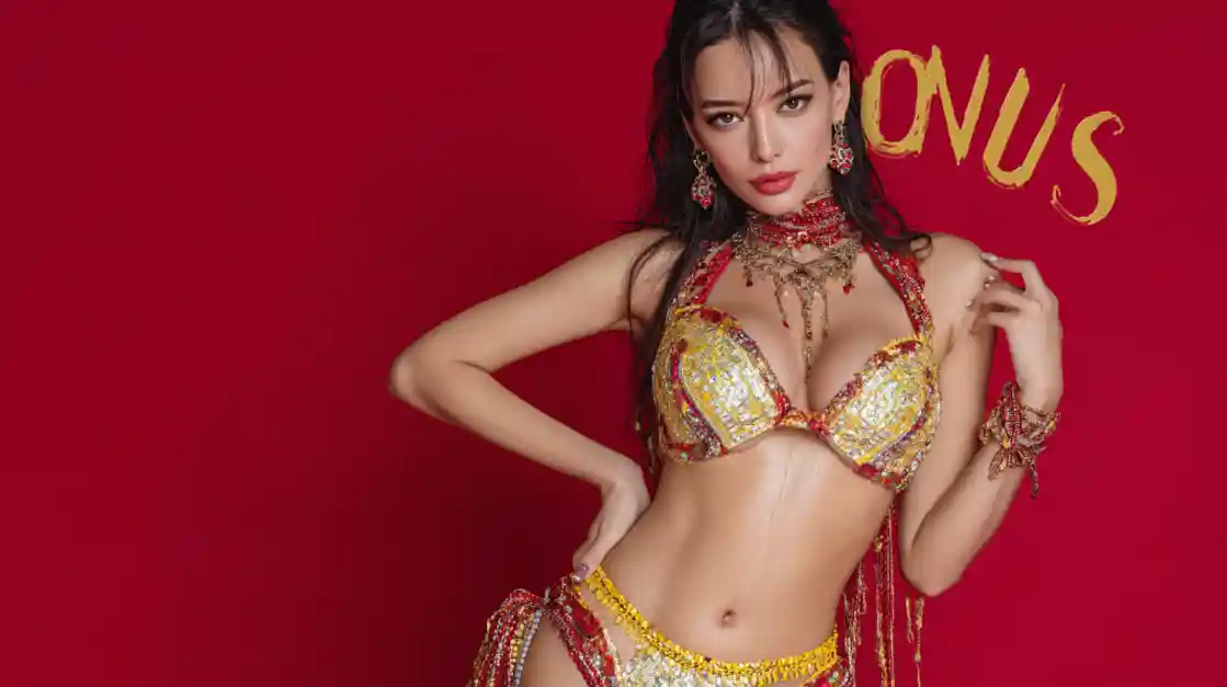 A glamorous model in a decorative red and gold outfit posing against a vibrant red background with the word BONUS in gold text.